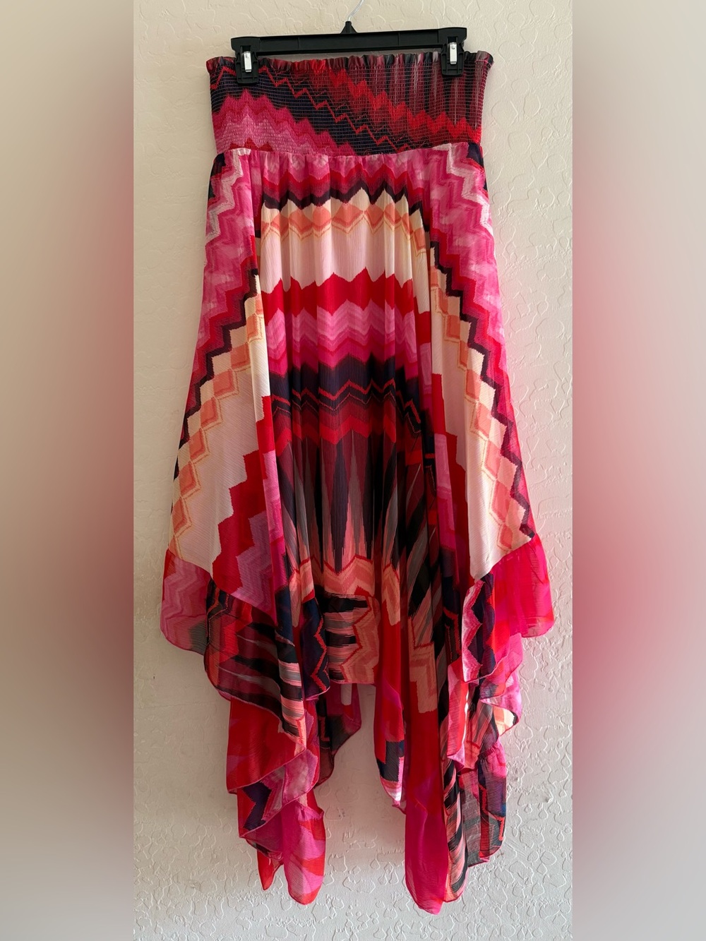 Lapis, large, pink zig-zag pattern pleated skirt with an asymmetric hem